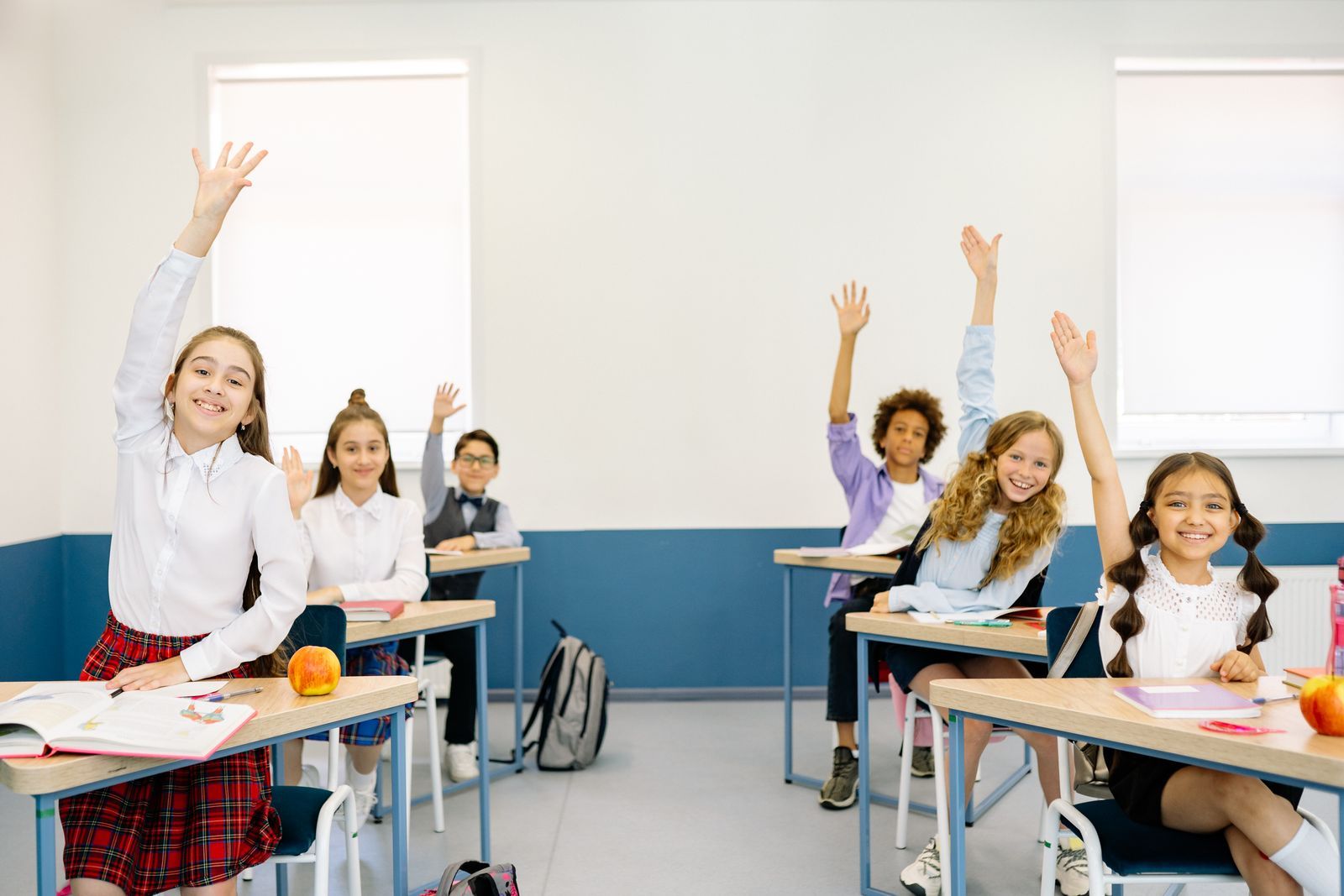 A Brightmind tutor working through a problem with a student in a bright teaching room