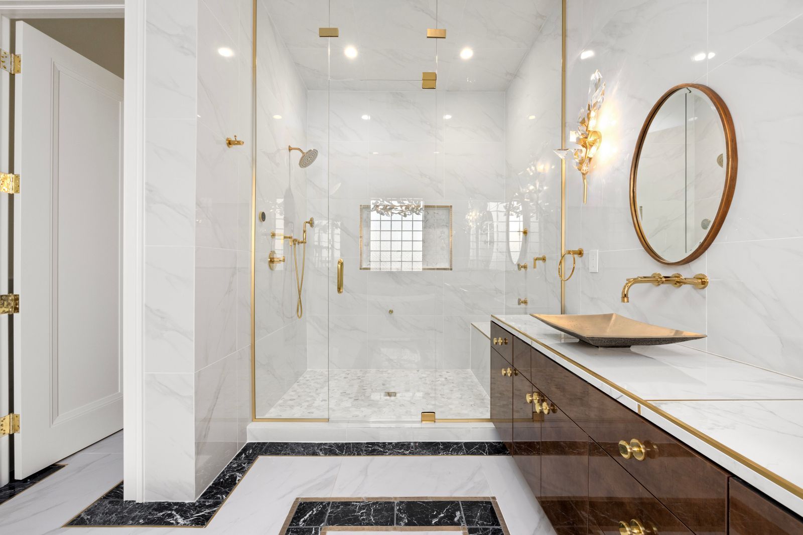The marble bathroom of a Meridian suite with a freestanding bath and twin basins