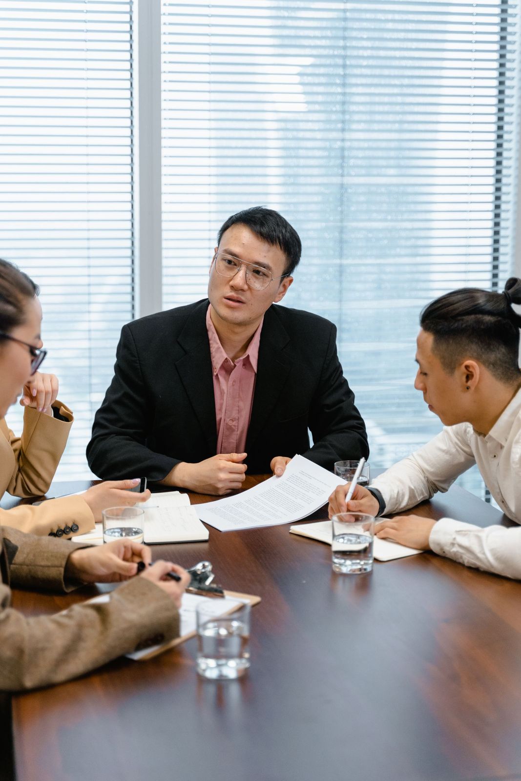 Tom Ashby in a meeting with two colleagues in the Crestwell boardroom