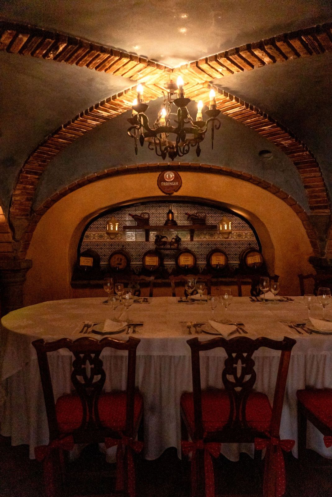 A corner of the dining room lit by the room's original chandelier
