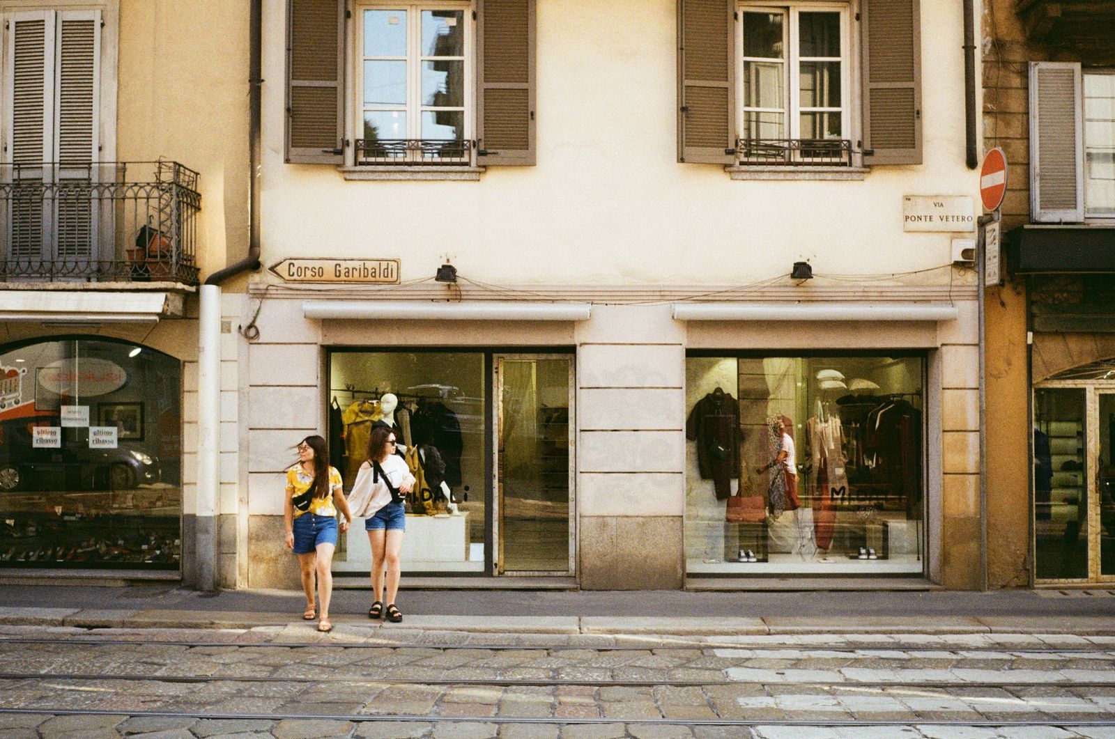 People looking in through the shop window of Morrow & Moss on Cheap Street