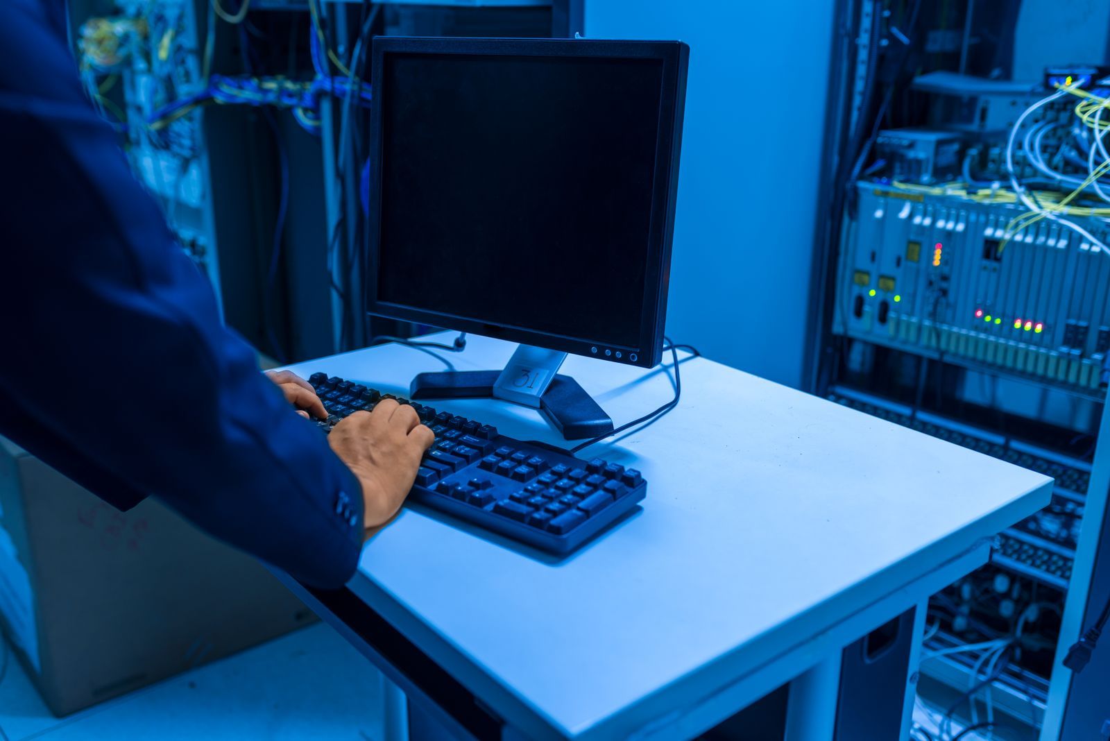 A Nexis field engineer working on client hardware during an onsite visit