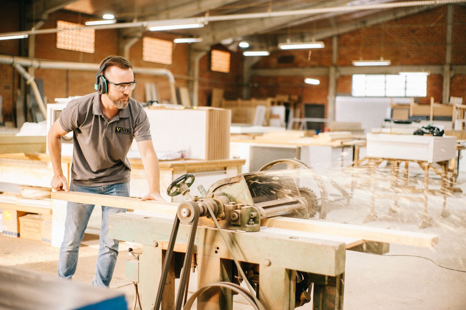 Carpenters working timber by hand in the busy Iron & Oak workshop at Penshurst