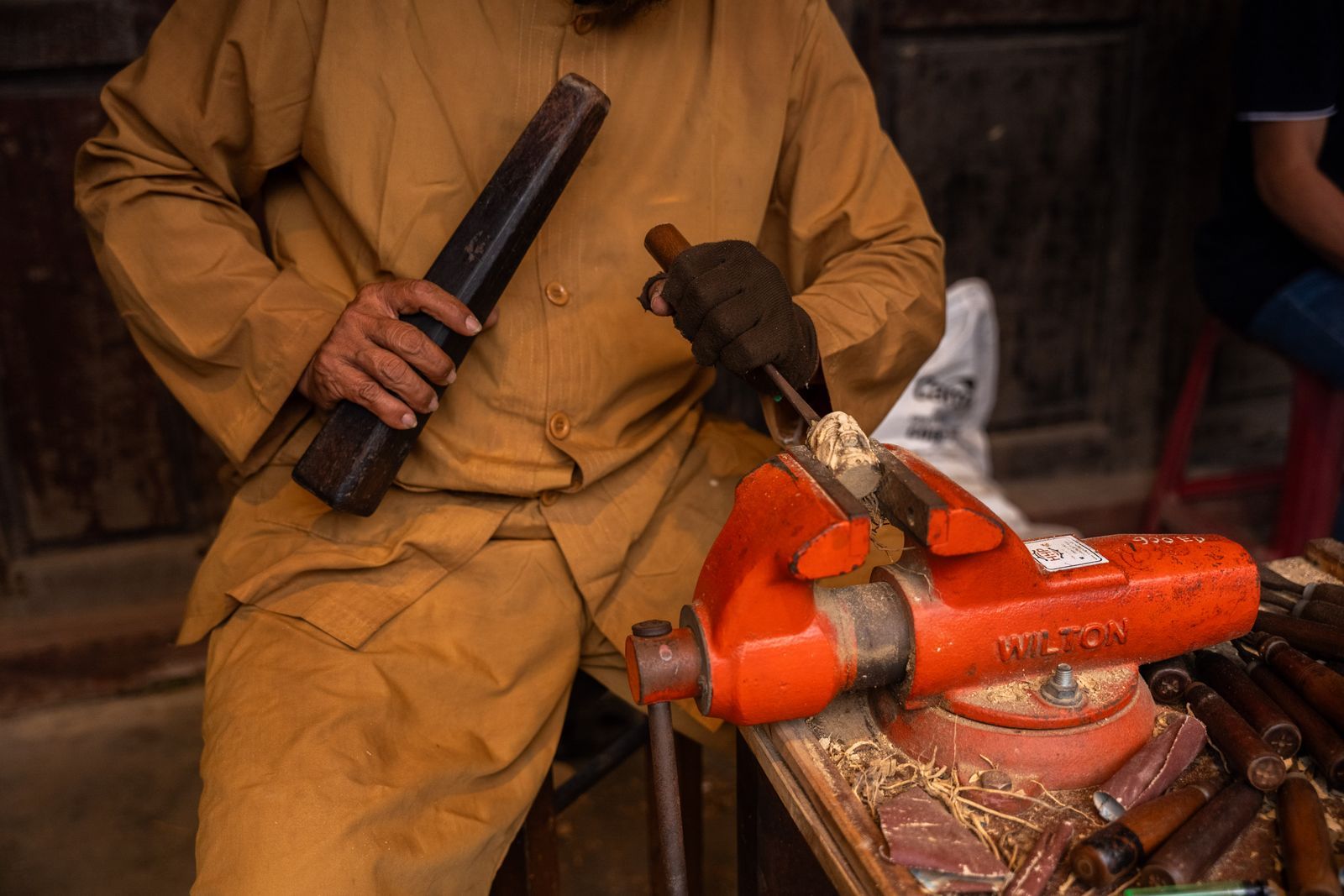 An Iron & Oak joiner hand-planing a length of English oak in the Penshurst workshop